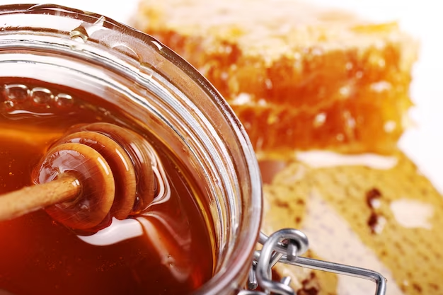 A close-up shot of honey syrup in a glass jar.