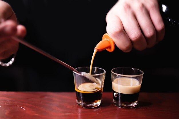 Coffee being poured into a shot glass